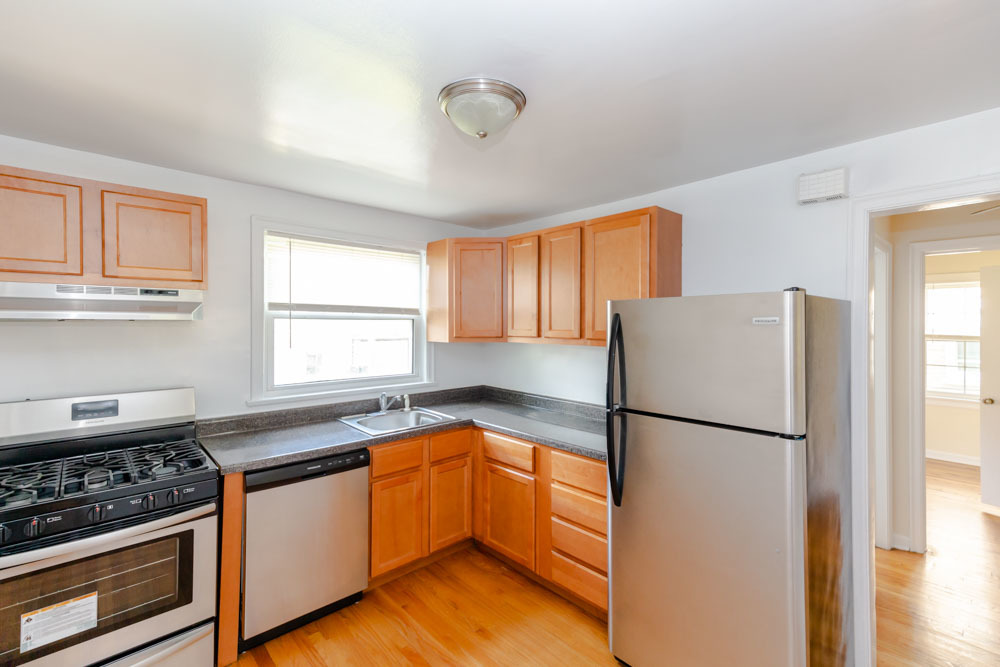 4245 West Nelson Street, Unit 1 Chicago, IL 60641 - Photo 2 of 9 a kitchen with a refrigerator sink and cabinets