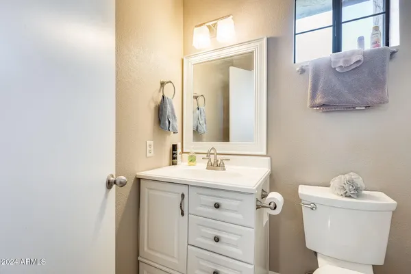 a white toilet sitting next to a bathroom sink