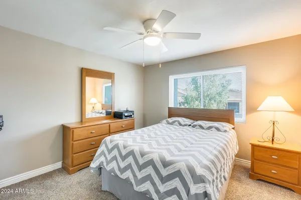 a bedroom with a large bed and a window