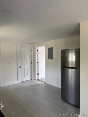 a view of a refrigerator in kitchen and wooden floor