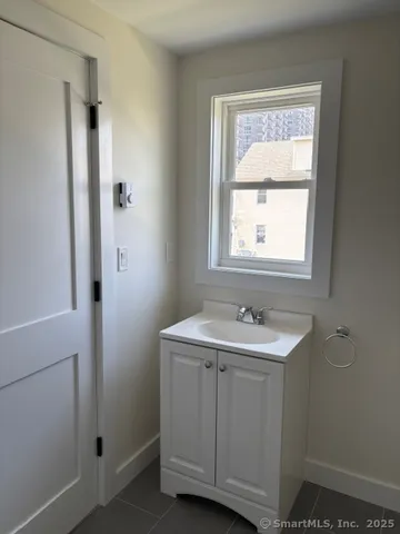 a bathroom with a sink and a window
