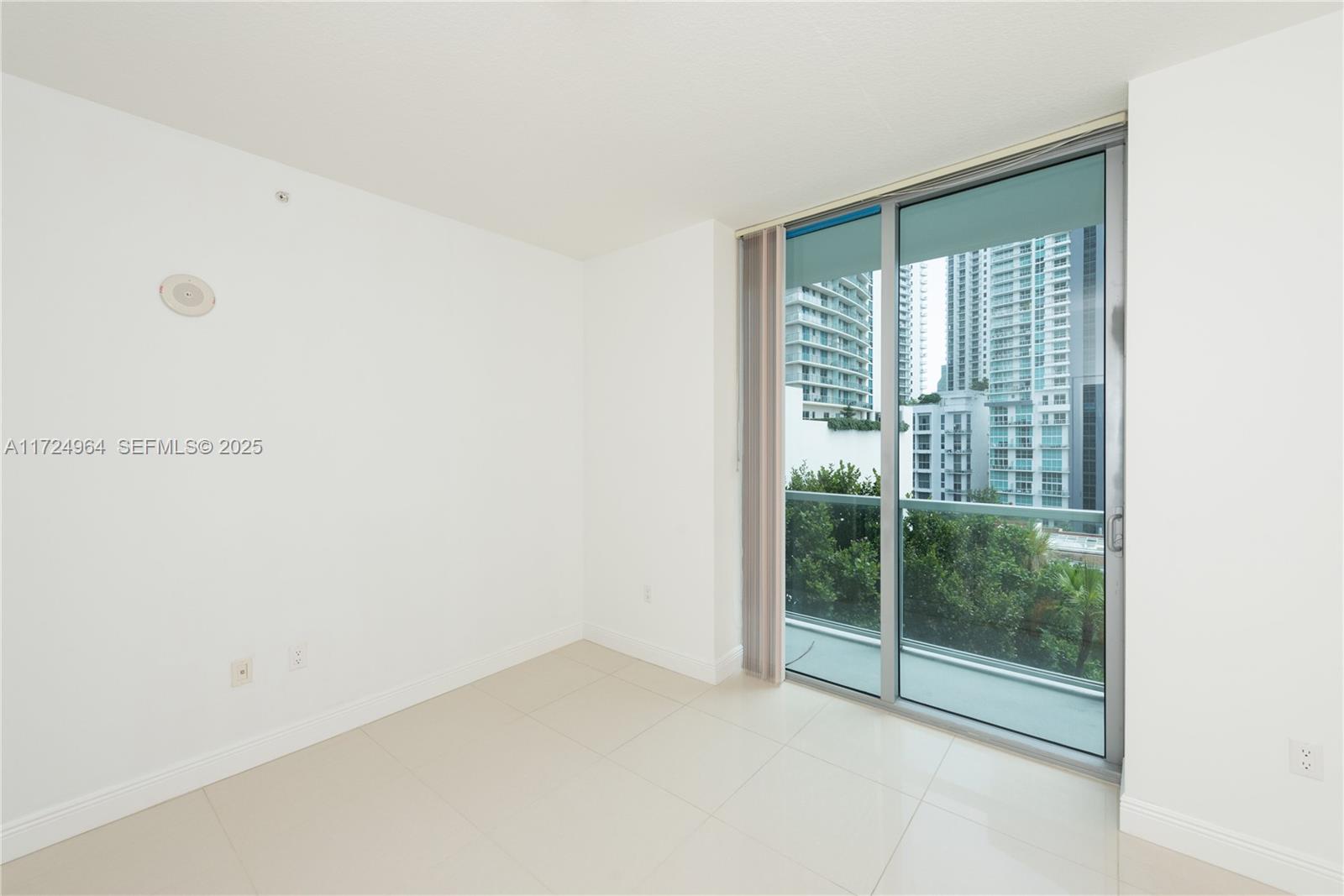 79 Southwest 12th Street, Unit 1107S Miami, FL 33130 - Photo 10 of 26 a view of an empty room with glass door