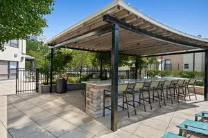 a living room with lots of furniture and large windows
