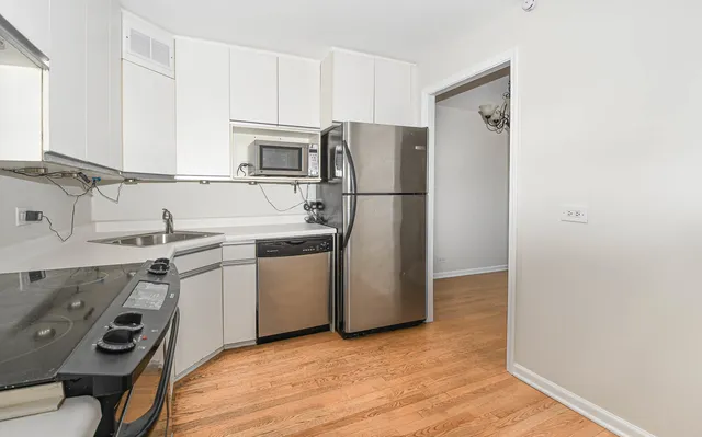 a kitchen with a refrigerator sink and stove