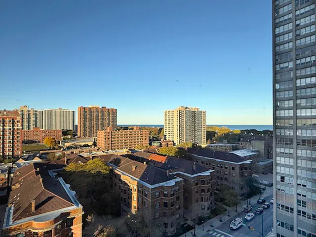 a living room with furniture fireplace and a large window