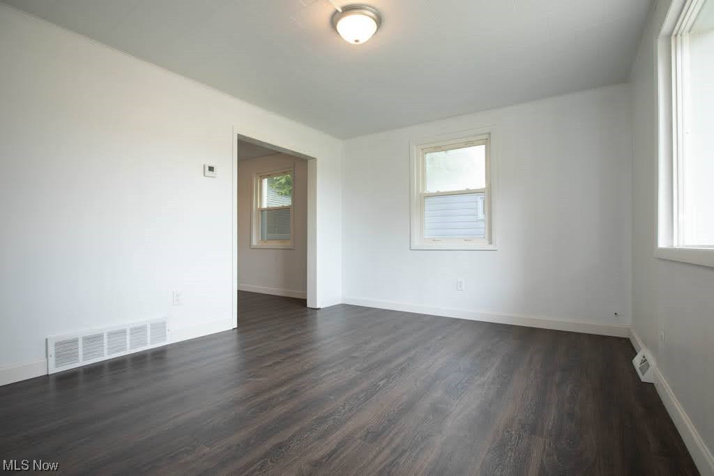 2310 Rockefeller Road Wickliffe, OH 44092 - Photo 3 of 35 Spare room with dark hardwood floors and a healthy amount of sunlight