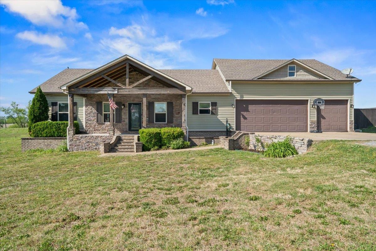206 Deen Road Brighton, TN 38011 - Photo 1 of 35 Stone and siding exterior with a covered front porch featuring exposed wood beams