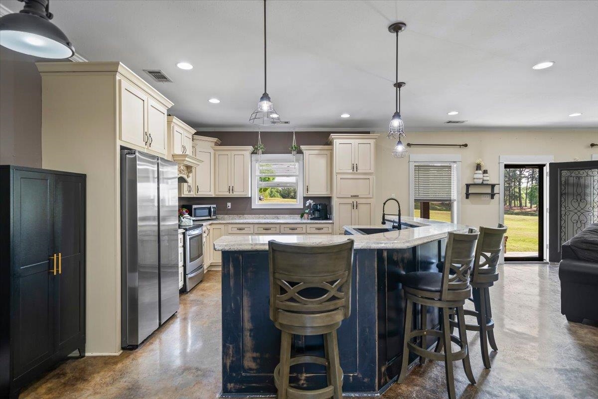 206 Deen Road Brighton, TN 38011 - Photo 12 of 35 Spacious kitchen featuring an expansive island with seating, pendant lighting, stainless steel appliances, and light-toned cabinetry