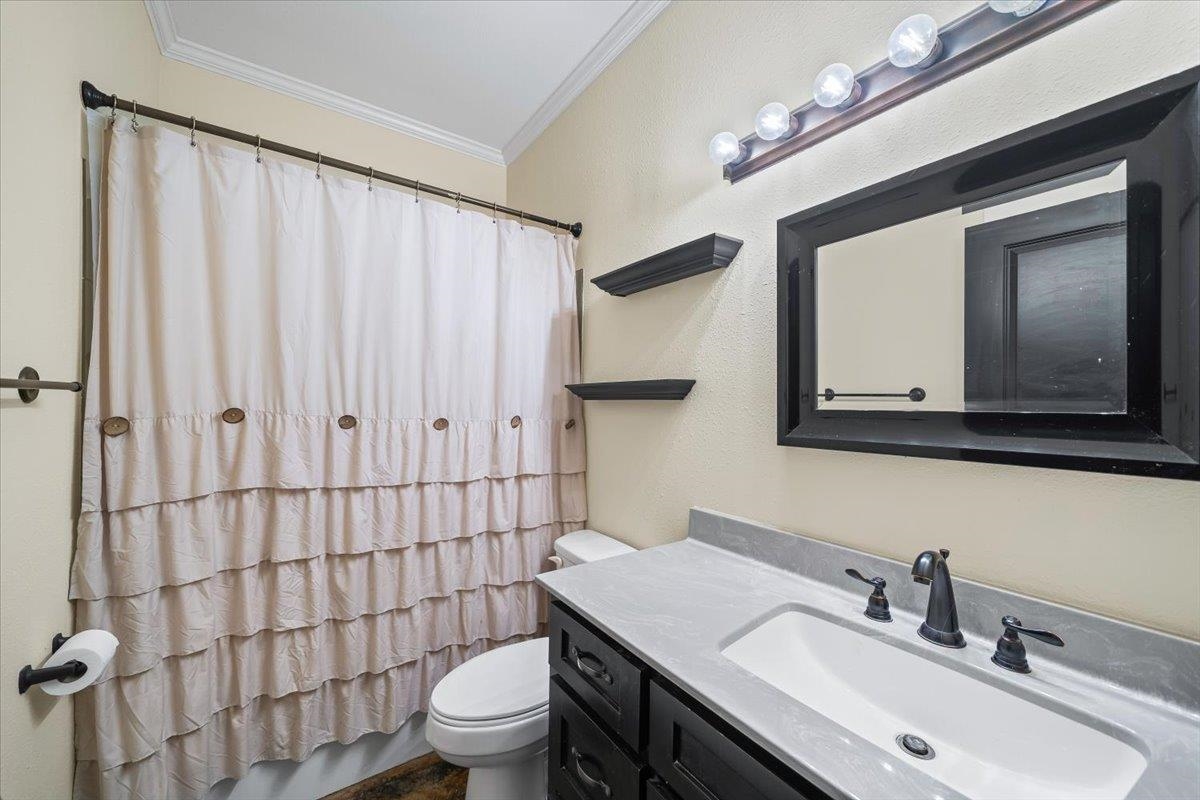206 Deen Road Brighton, TN 38011 - Photo 23 of 35 Bathroom vanity with a rectangular undermount sink, dark cabinetry, and a light-toned countertop