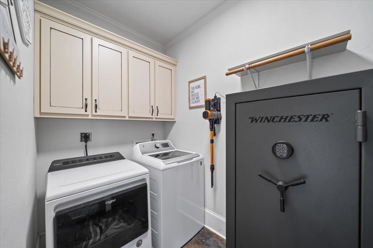 206 Deen Road Brighton, TN 38011 - Photo 24 of 35 Laundry area featuring light-toned cabinetry with dark hardware and a built-in wall shelf with a wooden rod