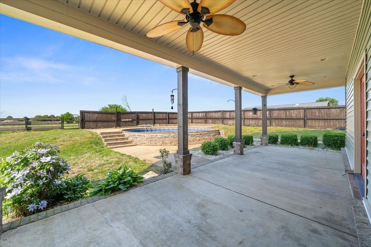 206 Deen Road Brighton, TN 38011 - Photo 30 of 35 Expansive covered patio with concrete flooring and two ceiling fans