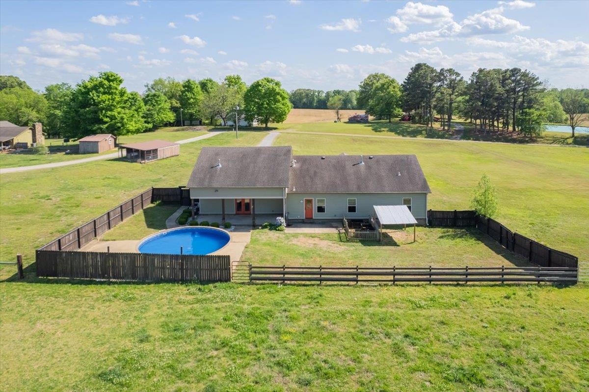 206 Deen Road Brighton, TN 38011 - Photo 31 of 35 Rear exterior featuring a swimming pool with surrounding concrete patio and wood privacy fencing