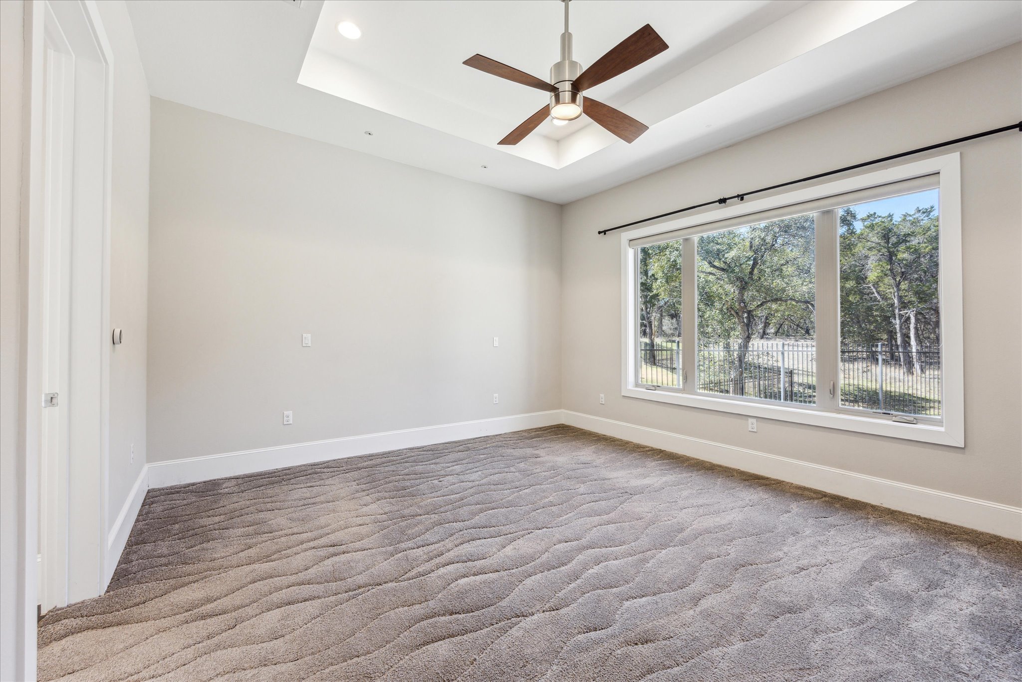 2604 Arion Circle Austin, TX 78730 - Photo 11 of 23 an empty room with wooden floor and windows