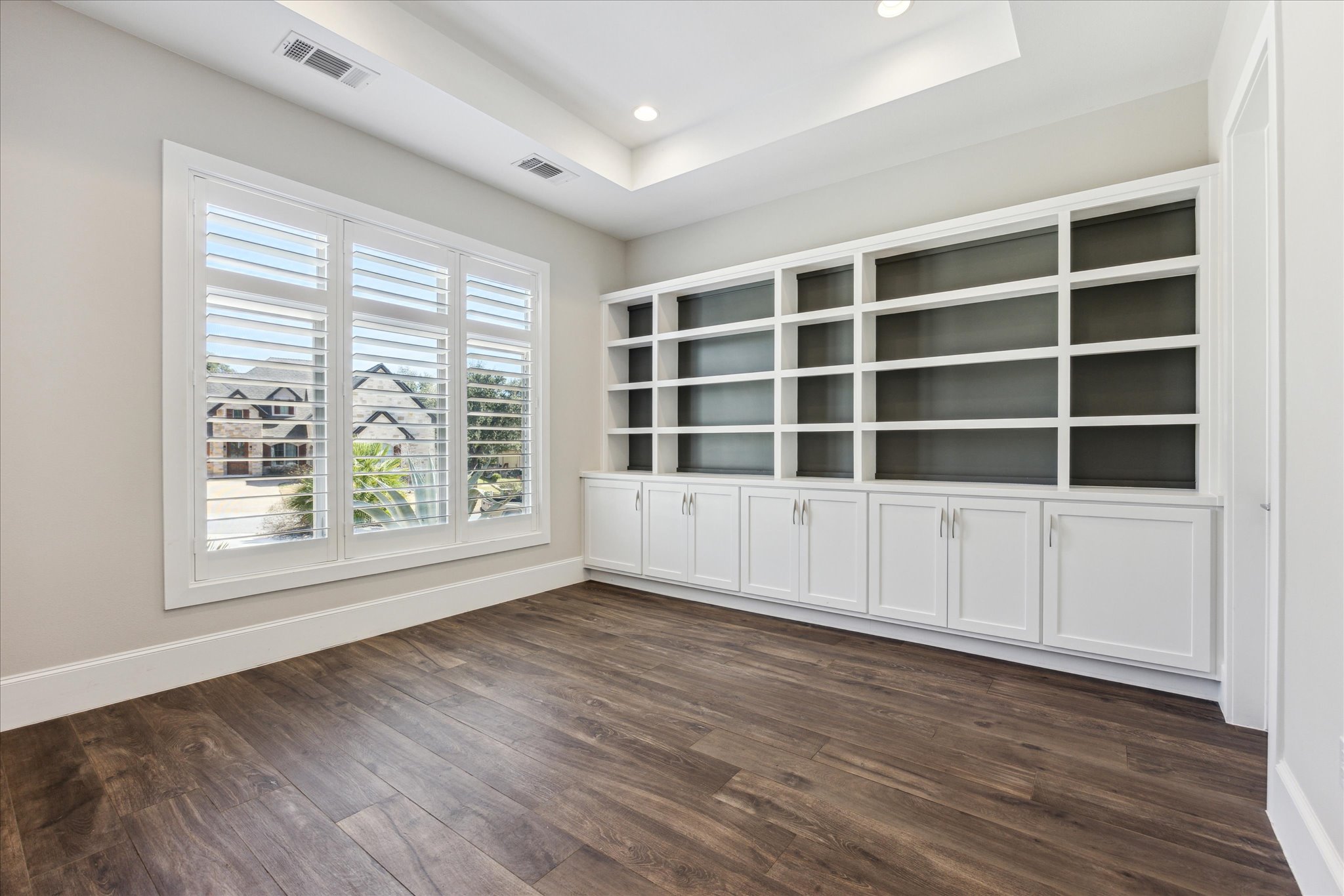 2604 Arion Circle Austin, TX 78730 - Photo 13 of 23 a view of an empty room with a window and wooden floor