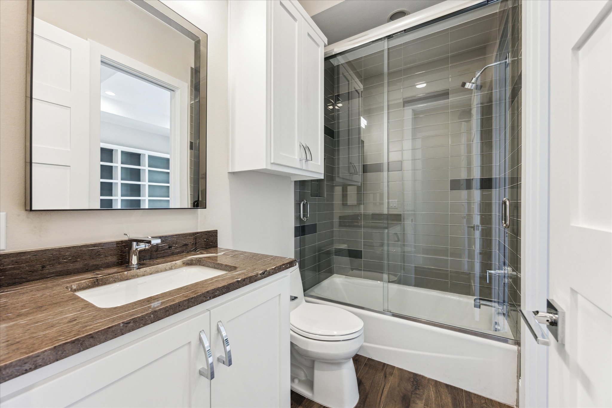 2604 Arion Circle Austin, TX 78730 - Photo 14 of 23 a bathroom with a granite countertop sink a toilet and shower