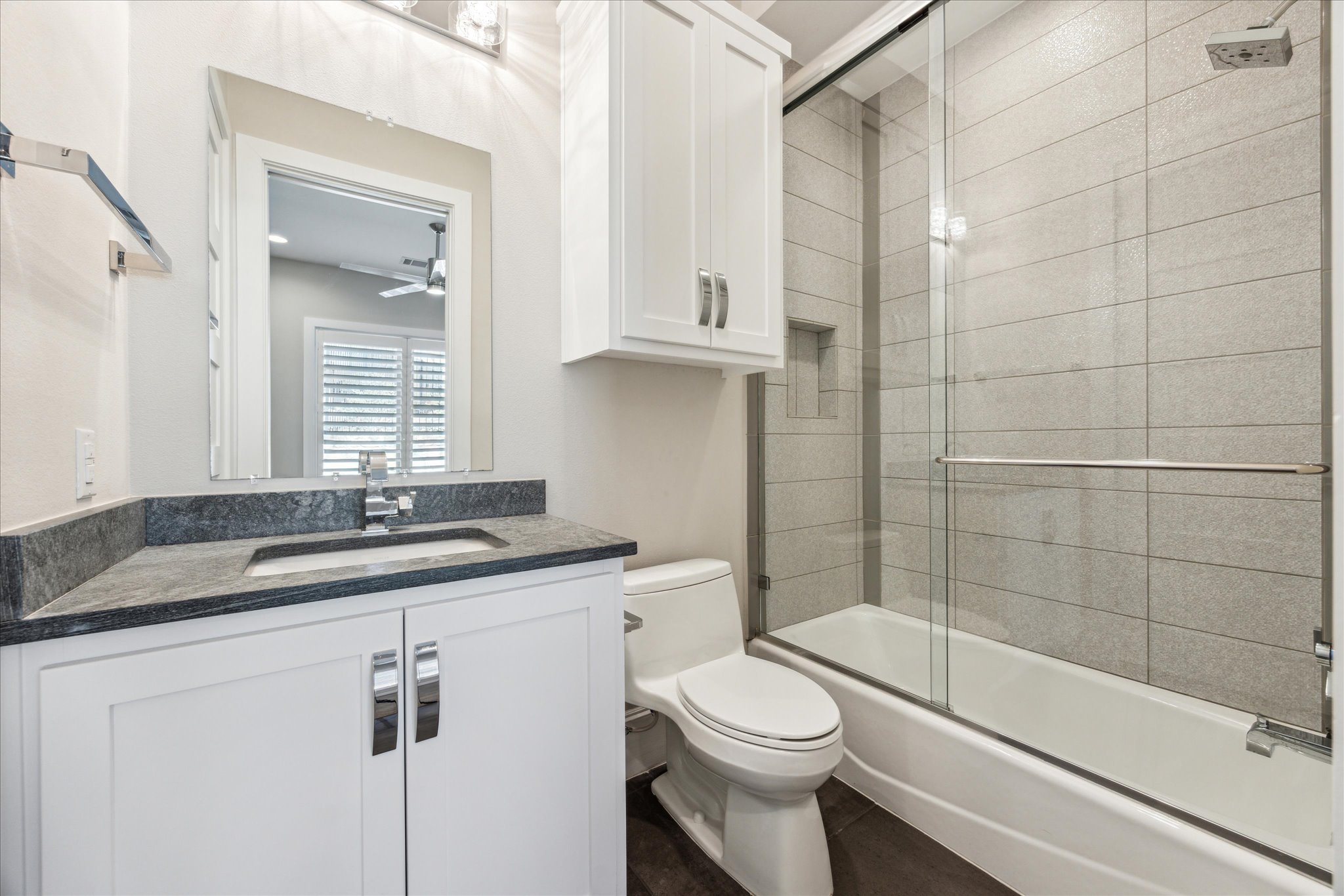 2604 Arion Circle Austin, TX 78730 - Photo 19 of 23 a bathroom with a granite countertop sink a toilet and shower