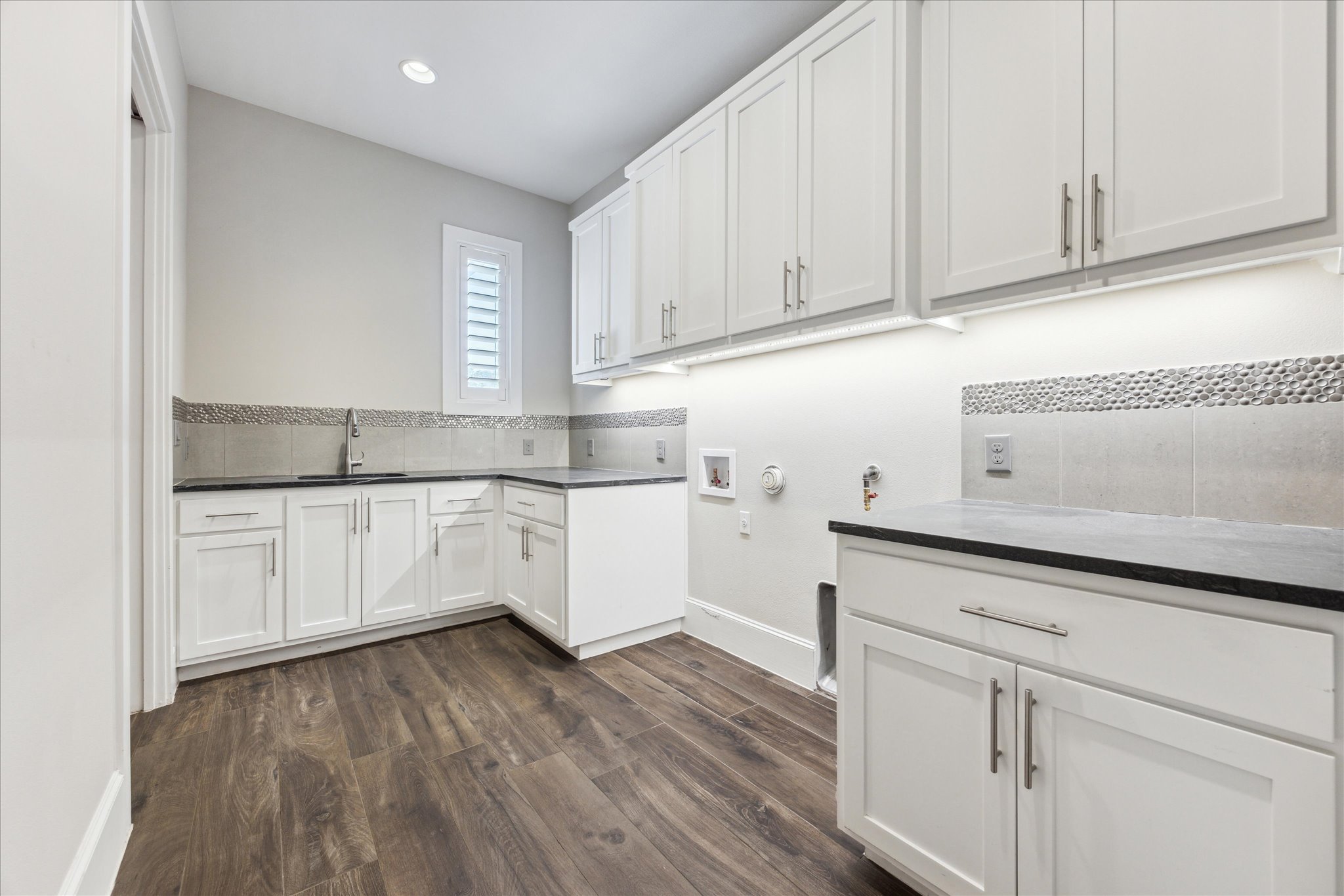 2604 Arion Circle Austin, TX 78730 - Photo 20 of 23 a kitchen with white cabinets and sink