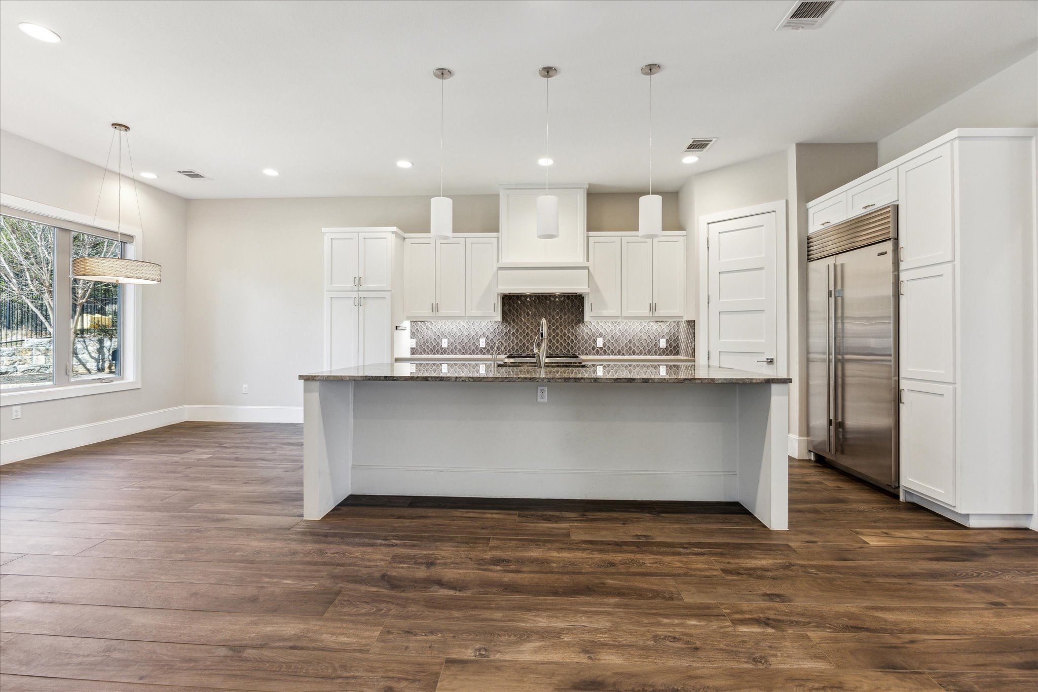 2604 Arion Circle Austin, TX 78730 - Photo 7 of 23 a view of kitchen with stainless steel appliances granite countertop cabinets and wooden floor