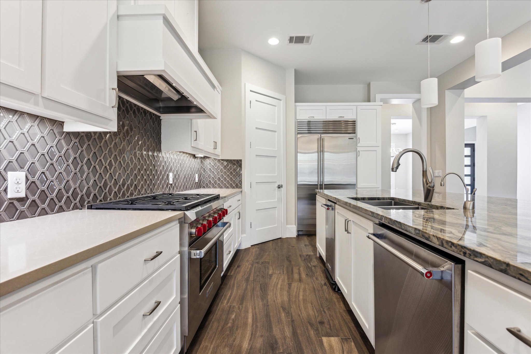 2604 Arion Circle Austin, TX 78730 - Photo 8 of 23 a kitchen with a sink stove and cabinets