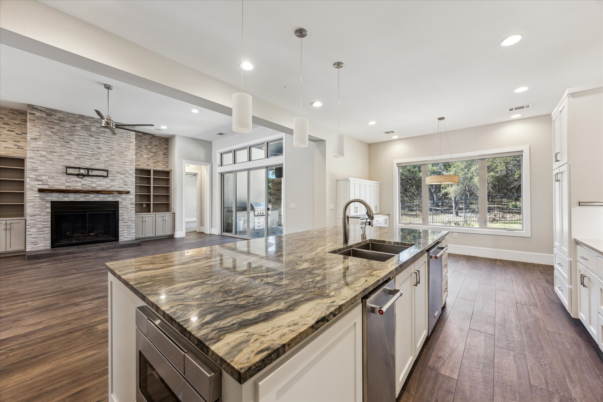 2604 Arion Circle Austin, TX 78730 - Photo 9 of 23 a kitchen with granite countertop stainless steel appliances a stove sink and wooden floor