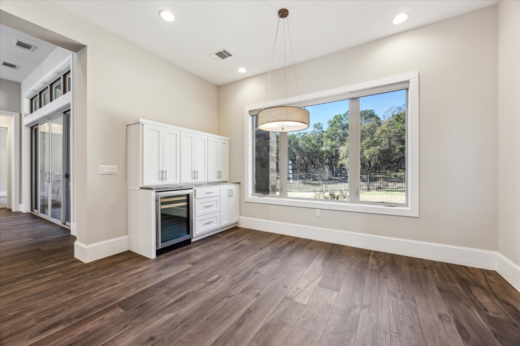 2604 Arion Circle Austin, TX 78730 - Photo 10 of 23 a view of a kitchen with wooden floor electronic appliances and windows