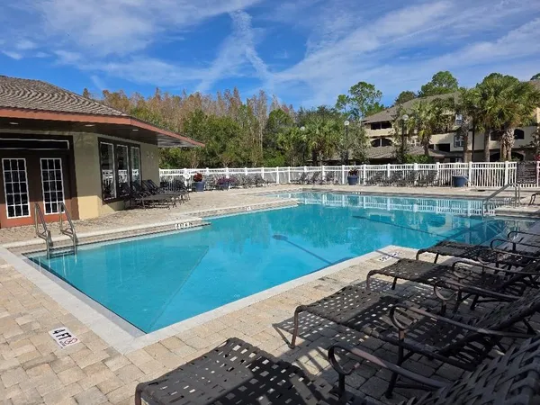 a view of a swimming pool with a lounge chair