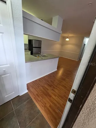 a view of a room with wooden floor