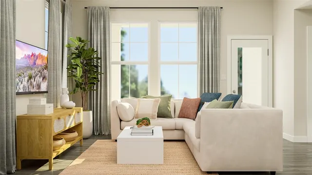 a living room with furniture and a potted plant