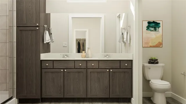 a bathroom with a granite countertop sink a toilet and a mirror
