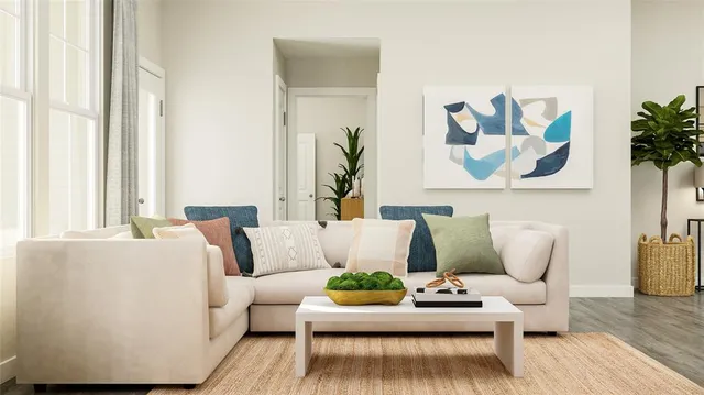 a living room with furniture and wooden floor