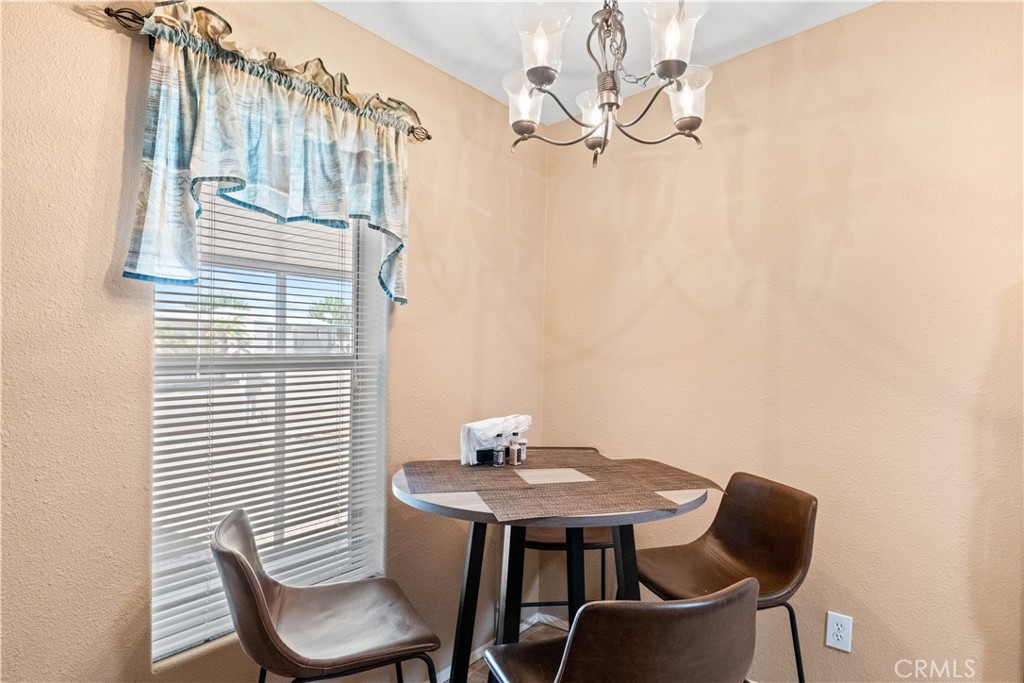 5900 Colorado River Road, Unit 18 Blythe, CA 92225 - Photo 11 of 58 a view of a dining room with furniture and wooden floor