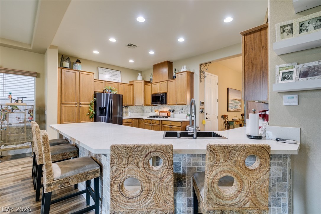 7524 Midnight Rambler Street Las Vegas, NV 89149 - Photo 18 of 51 Culinary delights await in this well-appointed kitchen, featuring a spacious island and quality appliances.