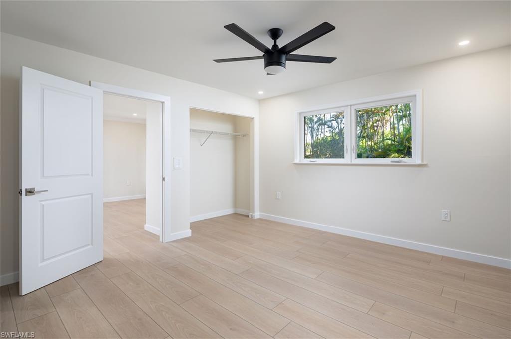 2424 Harbor Road Naples, FL 34104 - Photo 12 of 26 an empty room to ceiling fan and a window
