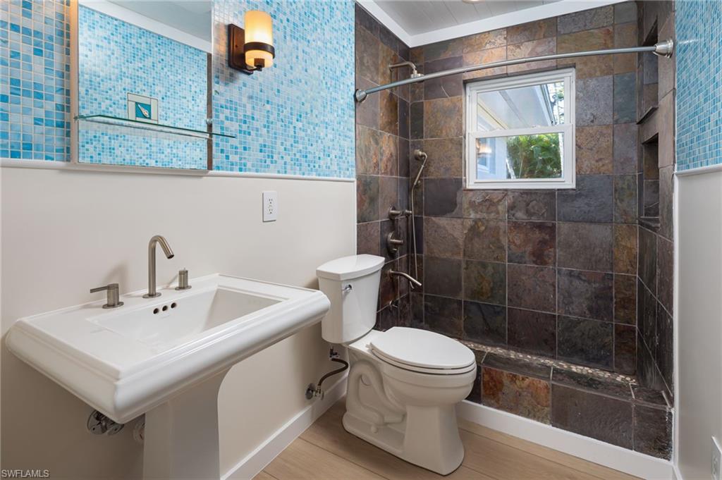 2424 Harbor Road Naples, FL 34104 - Photo 17 of 26 a bathroom with a sink a toilet and shower