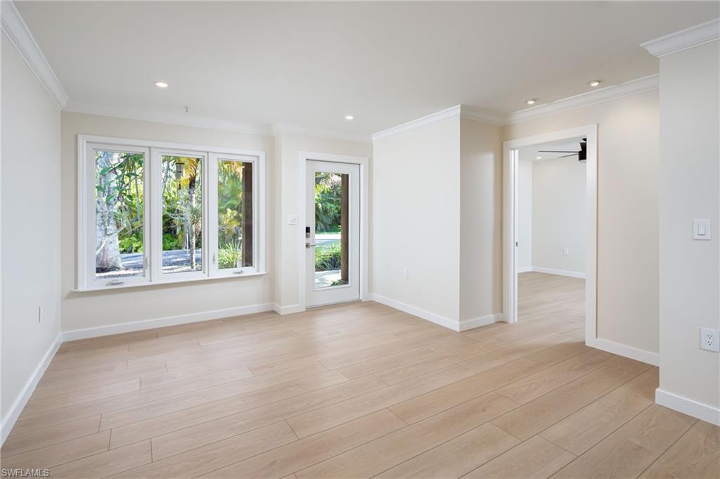 2424 Harbor Road Naples, FL 34104 - Photo 2 of 26 wooden floor in an empty room with a window