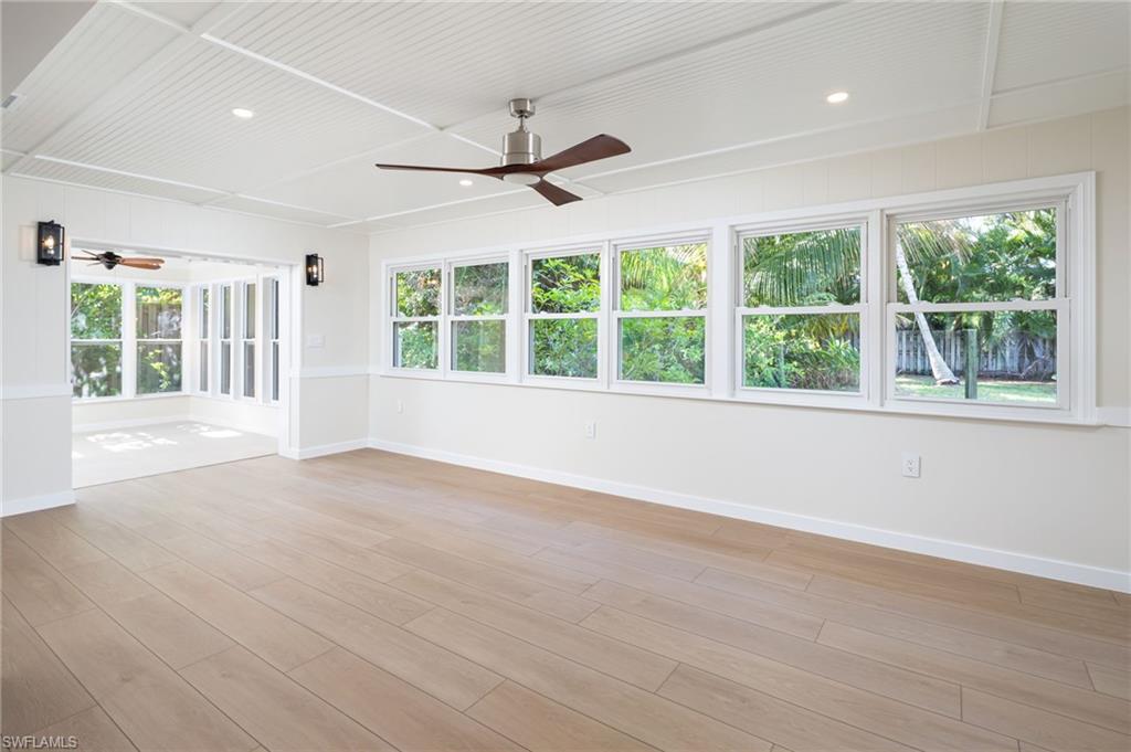2424 Harbor Road Naples, FL 34104 - Photo 9 of 26 a view of an empty room with a window and wooden floor