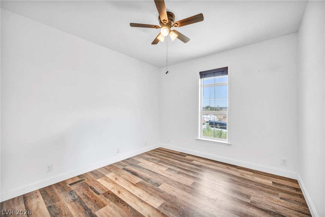 225 California Street Searchlight, NV 89046 - Photo 35 of 64 Hardwood-style flooring and a ceiling fan provide comfort in this naturally illuminated room.