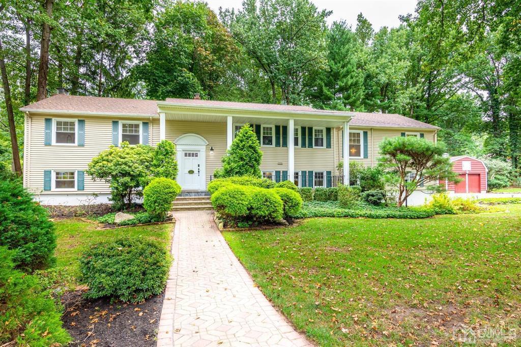 a front view of house with yard and green space
