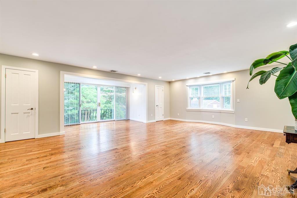 14 Tamarack Road Edison, NJ 08820 - Photo 17 of 40 a view of an empty room with wooden floor and a window