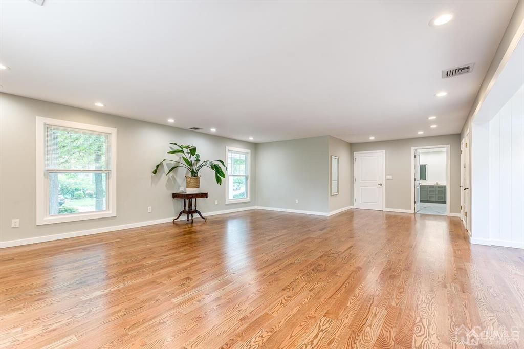 14 Tamarack Road Edison, NJ 08820 - Photo 18 of 40 a view of an empty room with wooden floor and windows