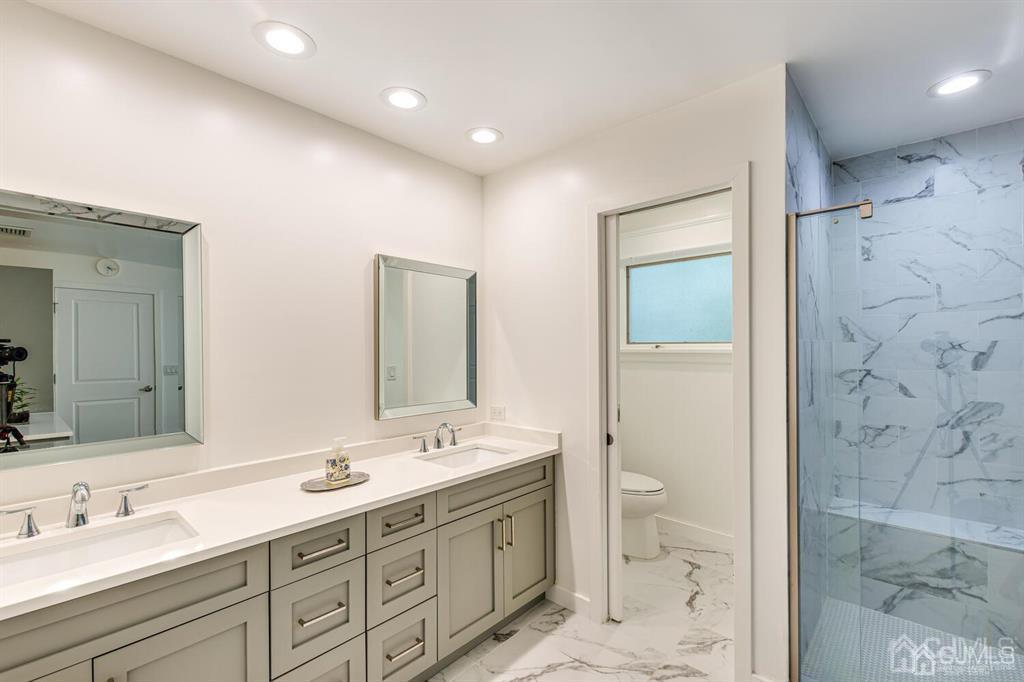 14 Tamarack Road Edison, NJ 08820 - Photo 23 of 40 a bathroom with a double vanity sink toilet and shower