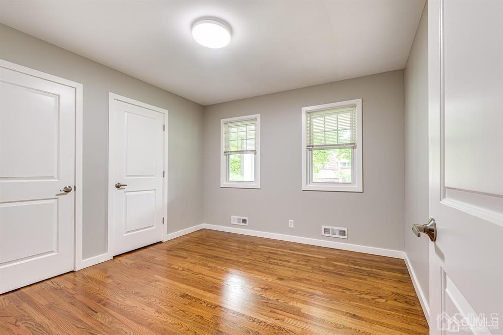 14 Tamarack Road Edison, NJ 08820 - Photo 25 of 40 an empty room with wooden floor and windows
