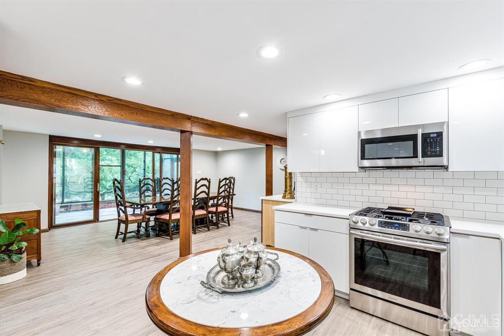 14 Tamarack Road Edison, NJ 08820 - Photo 35 of 40 a kitchen with sink a stove and chairs