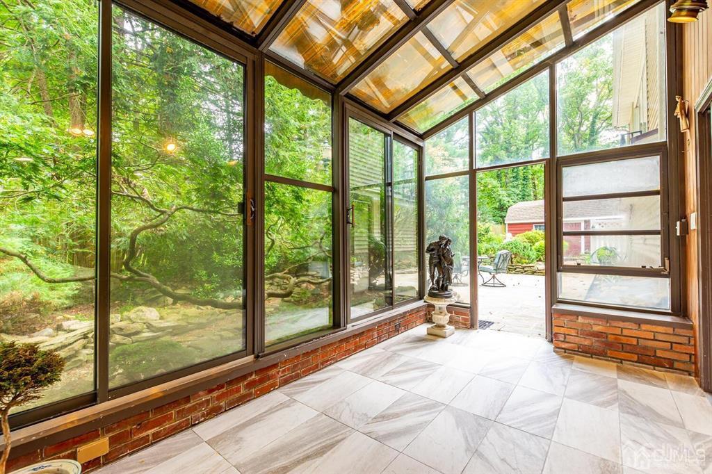 14 Tamarack Road Edison, NJ 08820 - Photo 36 of 40 a view of a room with large windows and wooden floor