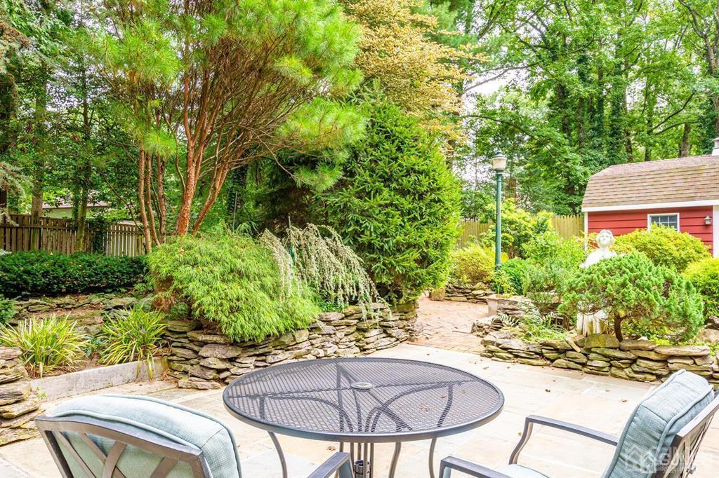 14 Tamarack Road Edison, NJ 08820 - Photo 37 of 40 a view of a backyard with table and chairs potted plants and large tree