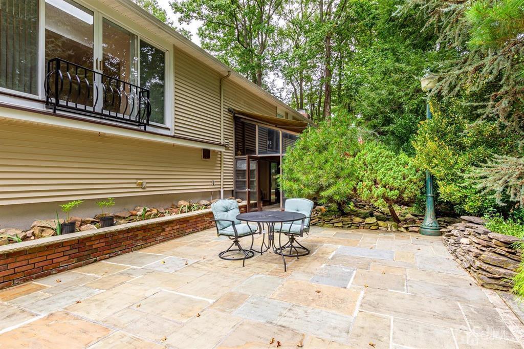 14 Tamarack Road Edison, NJ 08820 - Photo 38 of 40 a view of a patio with table and chairs and wooden fence