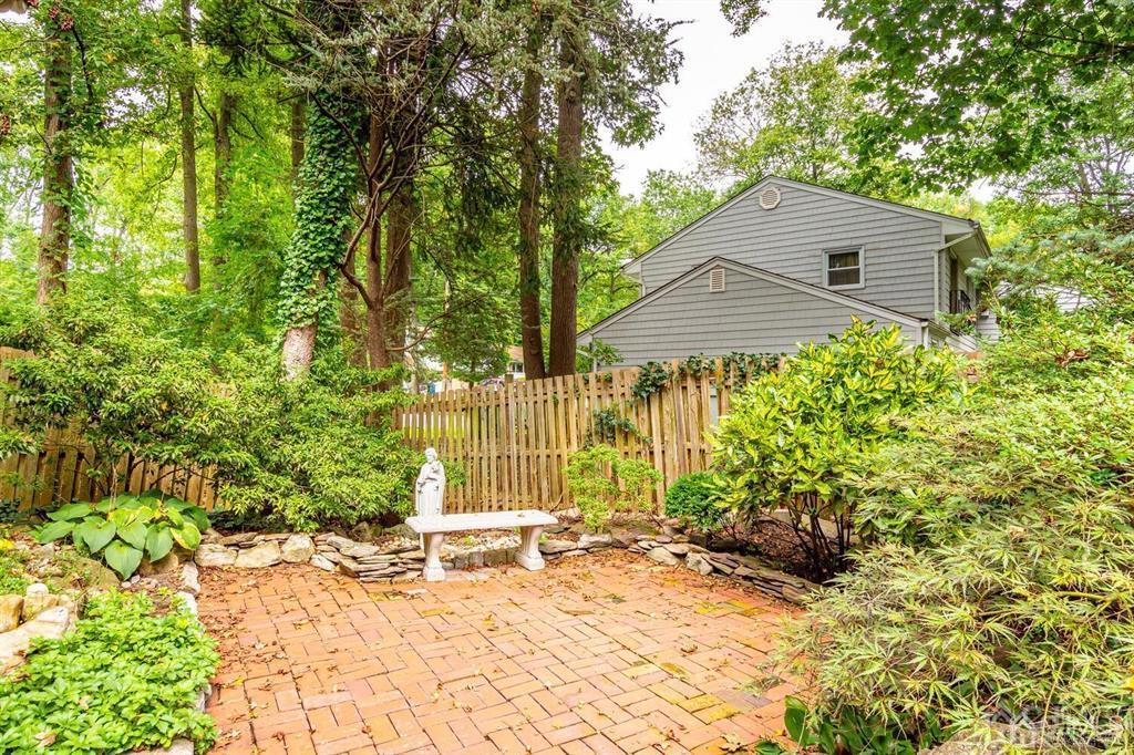 14 Tamarack Road Edison, NJ 08820 - Photo 40 of 40 a backyard of a house with large trees and plants