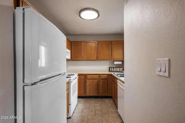 a utility room with cabinets washer and dryer