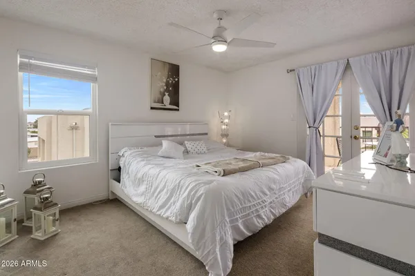 a bedroom with a bed and a window