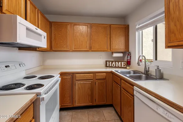 a kitchen with a sink cabinets and a window